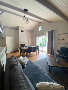 a living room with a couch and a dining room at Les granges du chiron in La Garnache