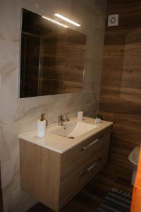 a bathroom with a sink and a mirror at Casa do Barreiro in Baião +15 photos