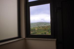 a window with a view of a mountain at Casa do Barreiro in Baião