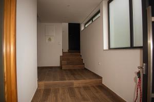 an empty hallway with stairs and a window at Casa do Barreiro in Baião