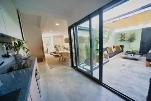 a kitchen and living room with sliding glass doors at Elements Milfontes - Japandi Designed House - City Center in Vila Nova de Milfontes +29 photos