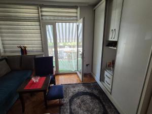 a living room with a couch and a table at City apartment in Prizren in Prizren +1 photo