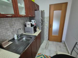 a kitchen with a sink and a microwave at City apartment in Prizren in Prizren