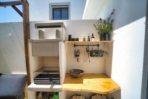 a play house with a table and a shelf at Elements Milfontes - Japandi Designed House - City Center in Vila Nova de Milfontes