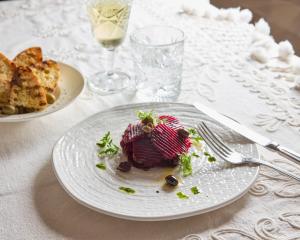 a plate with a piece of food on a table at La Casa E Il Mare, Private Bay Hotel in Mattinata