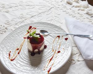 a dessert on a white plate on a table at La Casa E Il Mare, Private Bay Hotel in Mattinata