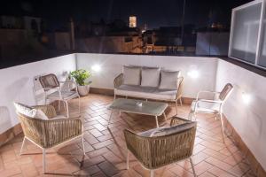 a balcony with chairs and a couch and a table at Torre Solana 41 in Cádiz +51 photos