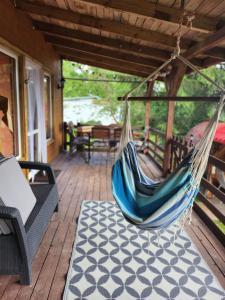 a porch with a hammock on a deck at Ranczo na Kaszubach in Parchowo