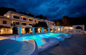 a hotel with a swimming pool at night at La Casa E Il Mare, Private Bay Hotel in Mattinata