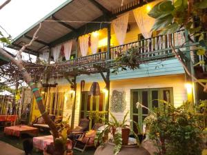 a house with a balcony and a patio at Baanrak amphawa homestay in Amphawa