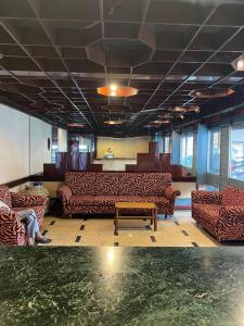 a room with couches and a table in a building at Hotel Skylark in Nagpur