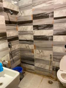 a bathroom with a toilet and a sink at Hotel Skylark in Nagpur +22 photos