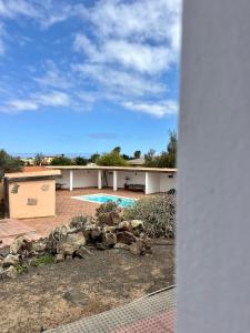 a view of a house with a swimming pool at Dreamwaves Surf House Fuerteventura in La Oliva +11 photos
