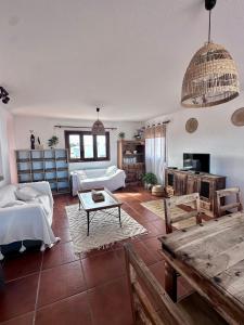 a large living room with two beds and a table at Dreamwaves Surf House Fuerteventura in La Oliva