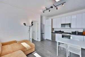 a kitchen and living room with a couch and a table at Bungalow near zoo and beach with AC, EV, private yard in San Diego