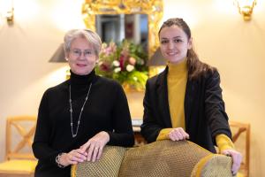two women sitting next to each other in a room at H&ocirc;tel Le Relais des Halles in Paris