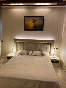 a bedroom with a large bed with two lamps on either side at Sahl Hasheesh, El Andalous by sea and pool view, private beach in Hurghada +20 photos
