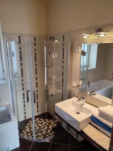 een badkamer met een wastafel en een douche bij LUX Apartman in Balatonfüred +91 foto's