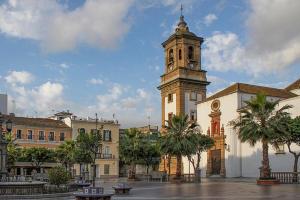a building with a tower with a clock on it at Costa by Hawkins Algeciras - Interior 2B in Algeciras