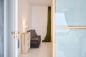 a living room with a couch and a chair at La Casa E Il Mare, Private Bay Hotel in Mattinata