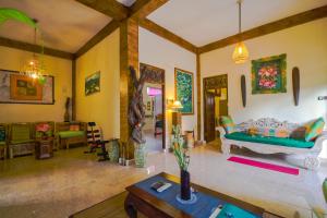 a living room with a couch and a table at Ume Sita Villa and Homestay in Ubud