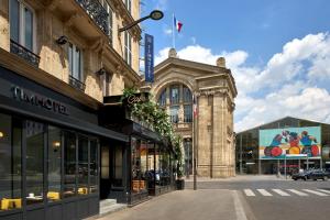 a city street with buildings and a street light at Timhotel Paris du Gare du Nord in Paris