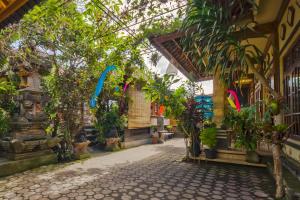 a courtyard of a building with trees and colorful ribbons at Ume Sita Villa and Homestay in Ubud