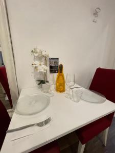 a white table with plates and wine glasses on it at Luxury 3 al duomo di parma in Parma +22 photos