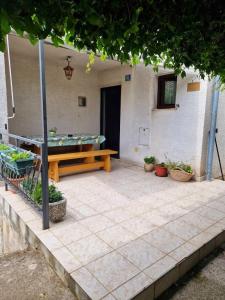 a patio with a ping pong table and potted plants at Apartman Seka in Kraljevica