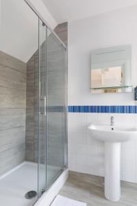 a bathroom with a shower and a sink at 4 Canon Lane in Chichester