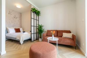 a living room with a couch and a bed at Good Mood Francuska Retreat - FREE PARKING - Self check-in in Katowice
