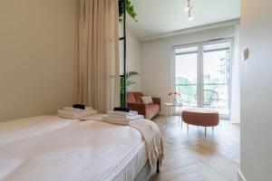 a bedroom with a bed and a living room at Good Mood Francuska Retreat - FREE PARKING - Self check-in in Katowice