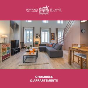 a living room with a couch and a table at Bordeaux Village Blaye in Blaye