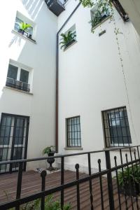 a building with windows and a balcony with plants at Santo Stefano Loft in Bologna