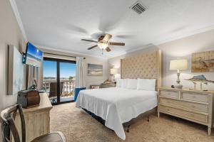 a bedroom with a bed and a ceiling fan at Cotton Bayou Unit 8C in Orange Beach +44 photos