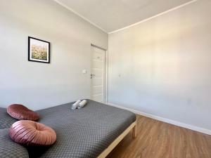 a bedroom with a bed with two pillows on it at MMRent Meadow Room in Gdańsk +11 photos