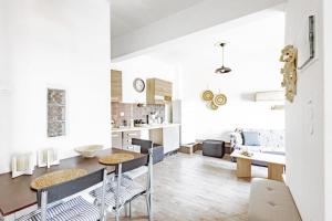 a kitchen and living room with a table and chairs at Isalos view in Skiathos