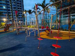 a playground with red chairs and a swing at Bali Melaka SeaView WaterPark 2-5Pax 5minJonker Projector in Melaka