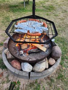 a grill with a hot dog on top of it at Mazury Kemp Jedwabno in Jedwabno