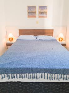 Una cama o camas en una habitación de Condomínio Residencial João Branciforti