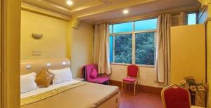 Postel nebo postele na pokoji v ubytování Hotel Tushar