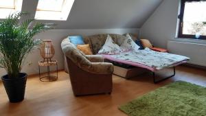 a living room with a couch and a table at Ferienwohnung Ankert in Finsterwalde