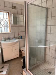 a bathroom with a shower and a sink at Ben Kalulu House in Mangeti +9 photos