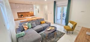 a living room with a couch and a table at Superior Apartment Lisinski - Private parking - 2 & 3 Bedroom in Zagreb