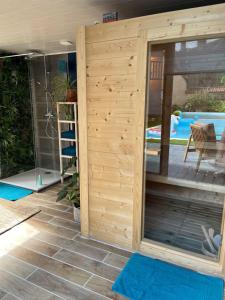 a wooden privacy wall in a backyard with a pool at Relais Saint-Jean Levroux in Levroux