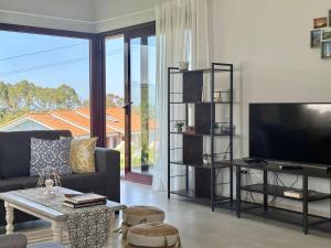 a living room with a couch and a large window at Vela Bianca - 12807 in Ajo