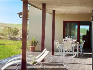 a patio with a table and chairs on a porch at Vela Bianca - 12807 in Ajo +17 photos