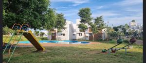 a playground with a slide next to a swimming pool at Villa 65 - Eco Village - No Alcohol Zone in Yelagiri