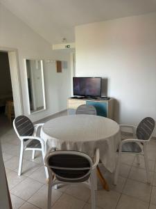 a room with a table and chairs and a tv at Kuća Roza in Rukavac
