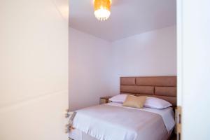 a bedroom with a bed and a chandelier at Two bedroom apartment Karmen with pool in Sinj +81 photos